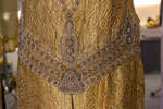 Это платье декорировано сотуаром и поясом, вышитым разноцветным бисером, стеклярусом и пайетками